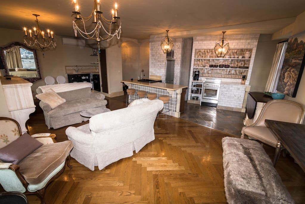 Living room, wet bar and kitchen looking towards the entrance hall
