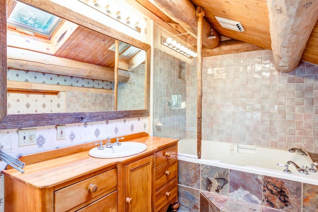 Master bath with shower and a large tub with jets.