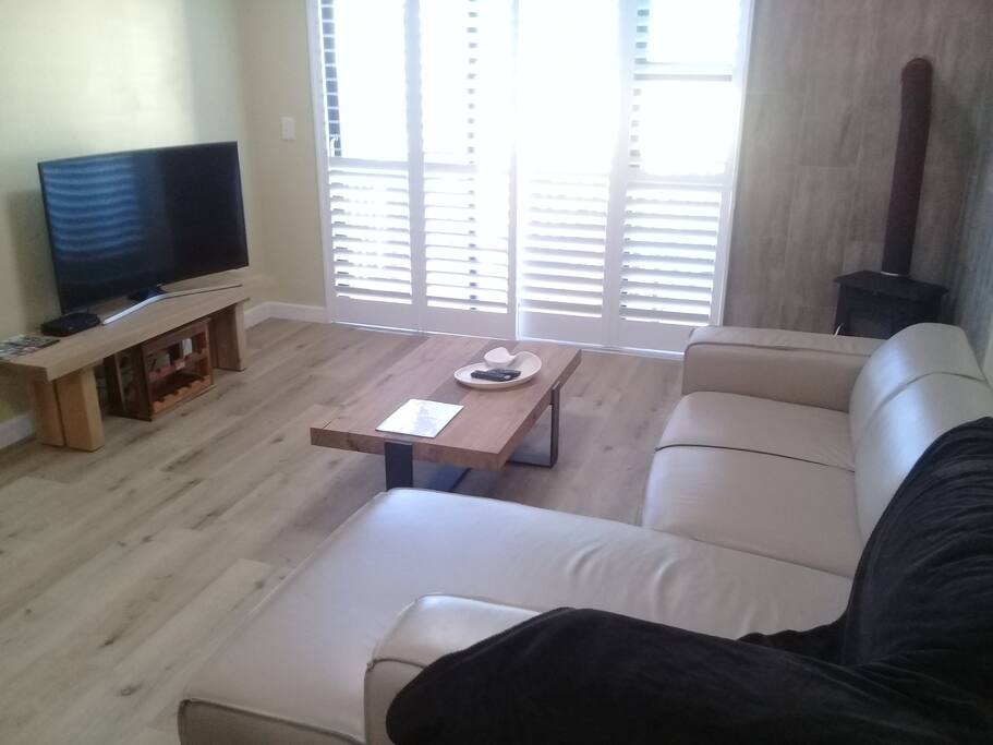 Lounge with balcony and Large Curve TV
