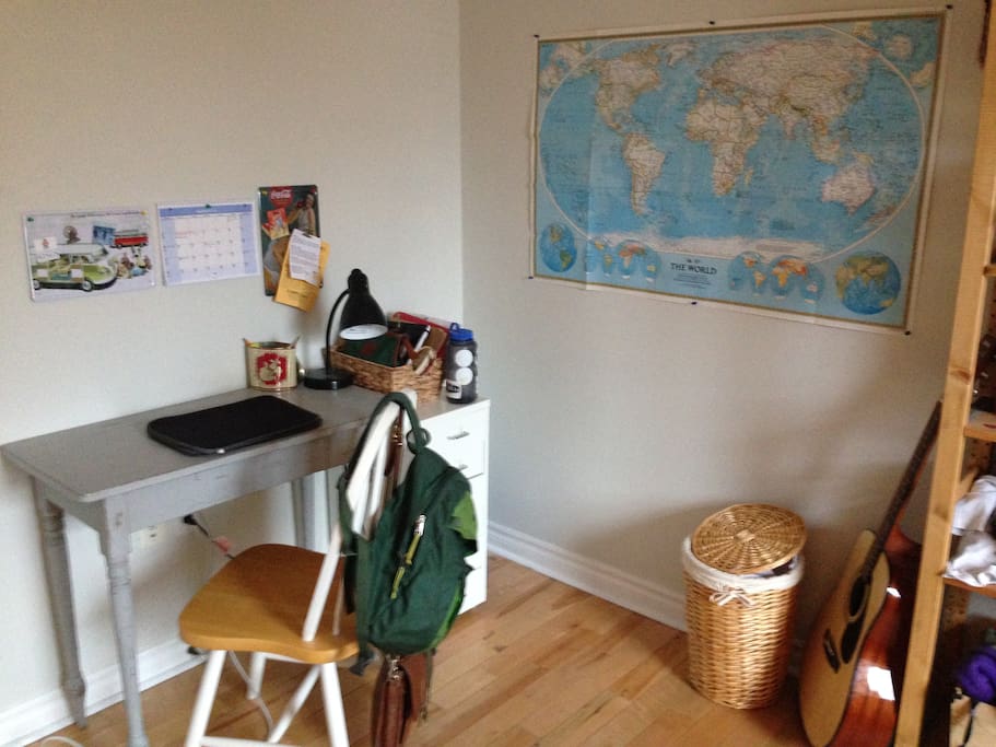 Other side of the room holds a bookcase, desk and chair.