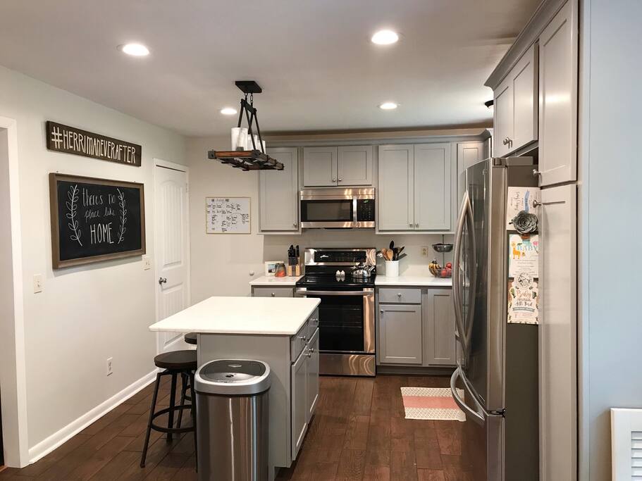 Newly renovated kitchen with new stainless steal appliances. Island with 2 bar stools.