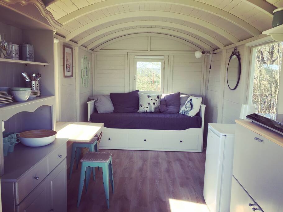 Living space with bedsofa, kitchenette and storing space