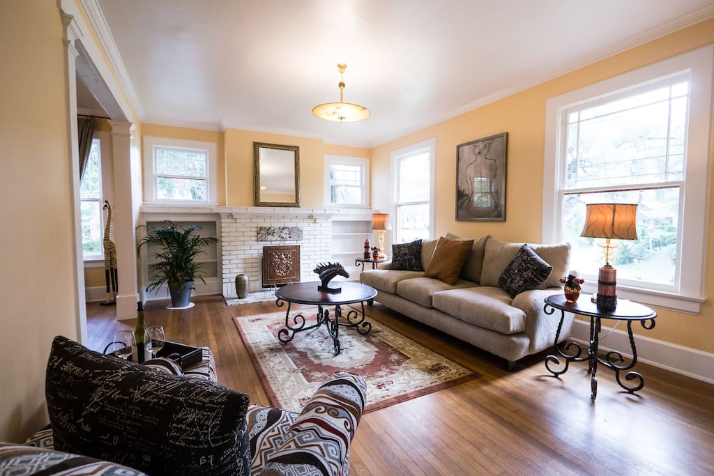 Beautiful living room with art deco lighting from Europe has a wood burning fireplace
