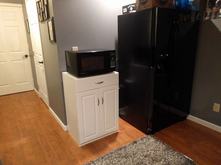 Refrigerator and microwave available for use (coffee-maker now sits on microwave), also a view of doors to the listing and bathroom.