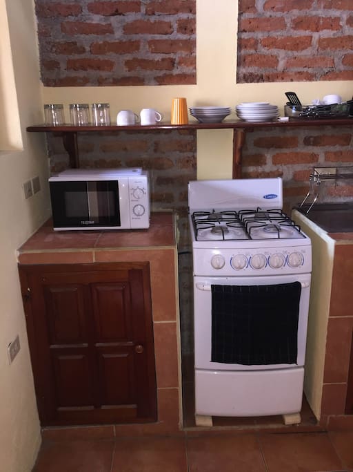 Microwave oven, cabinets, gas stove and oven.
