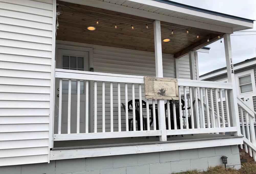 Exterior of unit w/private covered porch, outdoor seating & mood lighting