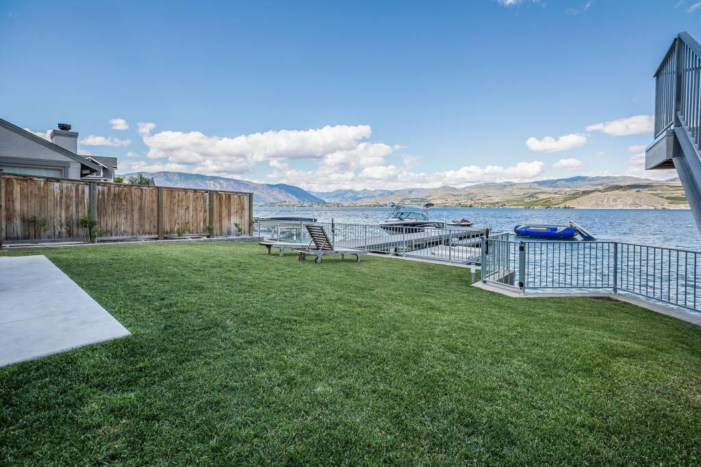 Completely fenced in grassy backyard.
