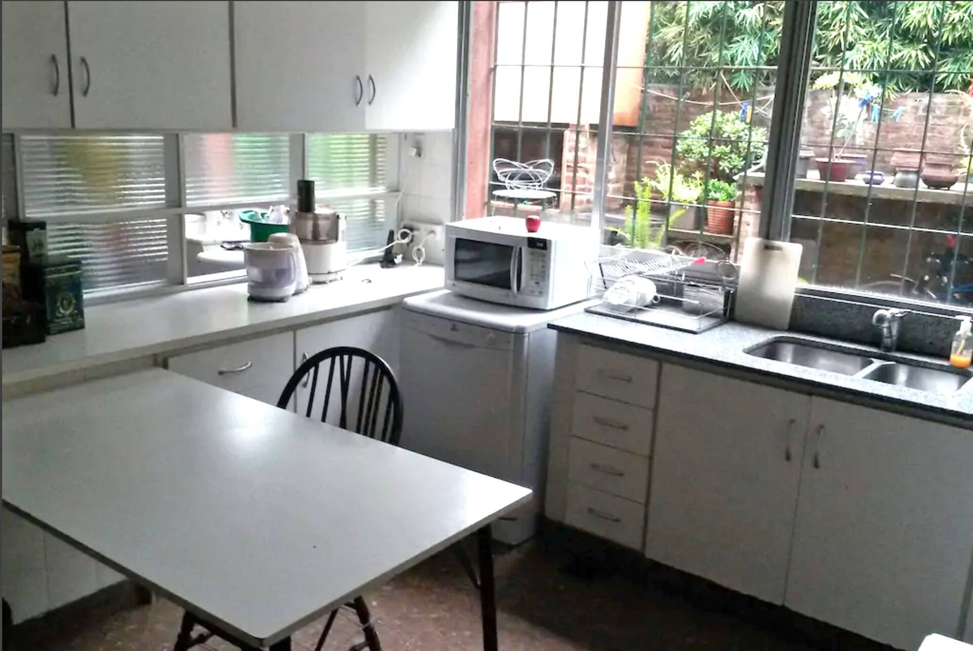 A room in a house overlooking a large garden