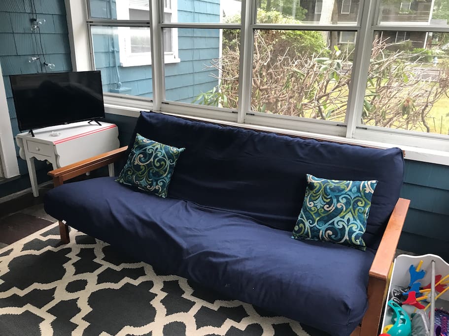 Three season room. This futon can sleep an addition person and isn't included in the bed count.