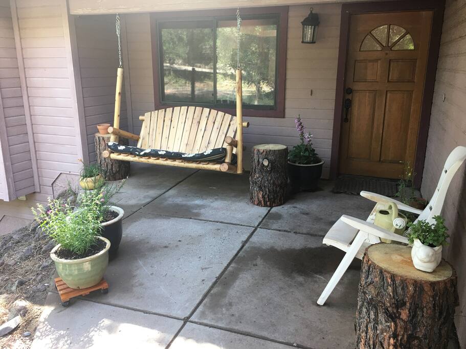 Front porch with swing. I try to have plants that attract hummingbirds, when it's their time of the year.