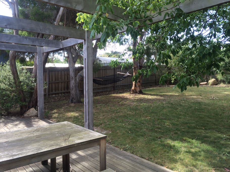Large shady backyard with outdoor table, hammock and bbq