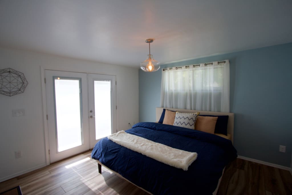 King room with french doors leading to courtyard.