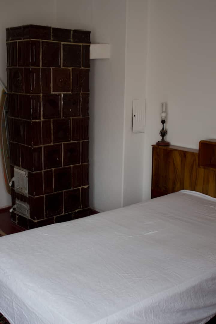 Bedroom One: authentic Transylvanian terracotta fireplace. 375cm x 430cm