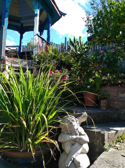 A generous and varied garden full of herbs, fruit trees and flowers. And the gazebo behind.