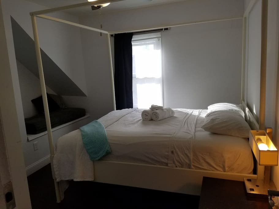 Queen canopy bed with pillowtop mattress and custom storage cabinetry