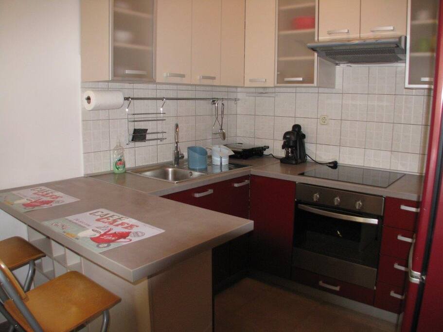 Nice cozy kitchen with coffee maker & burger toaster.