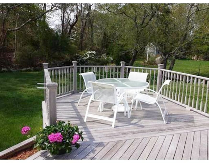 Dining deck overlooking pool and yard.