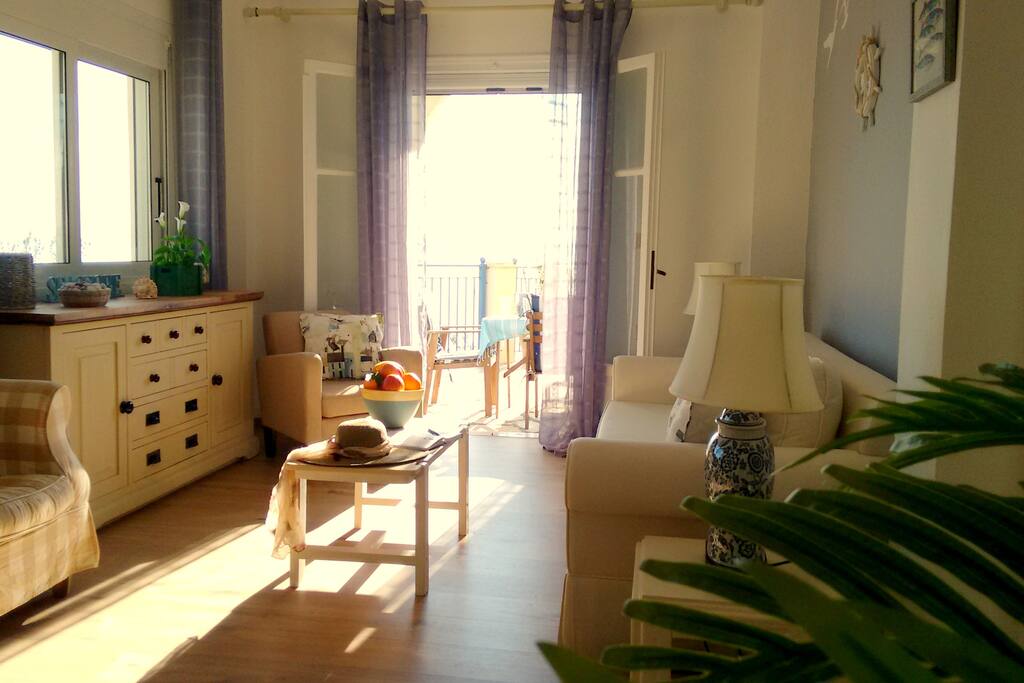 Living room with doors on to the sunny terrace.