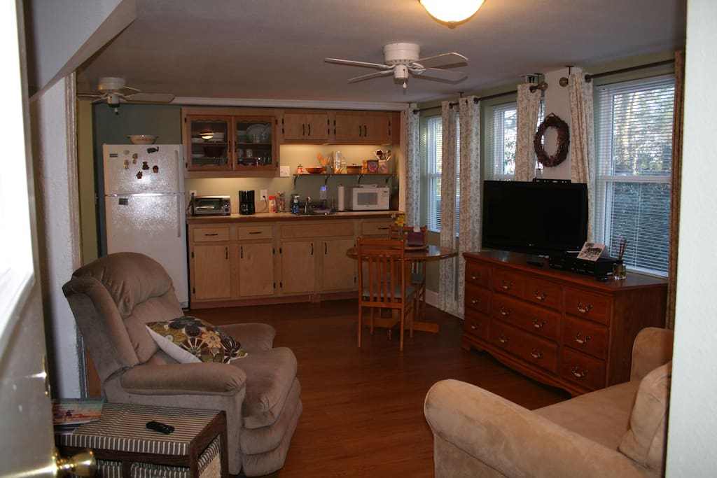 kitchen with microwave, toaster oven, coffee pot, refrigerator, and dinette