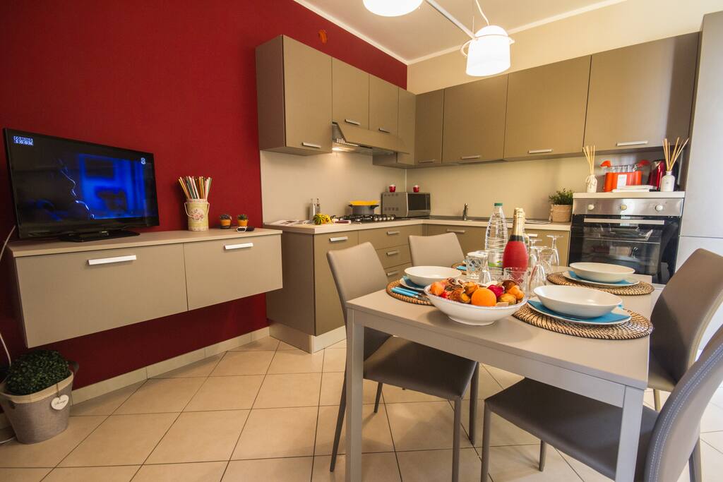 Fully fitted modern kitchen with a dishwasher and a dining set