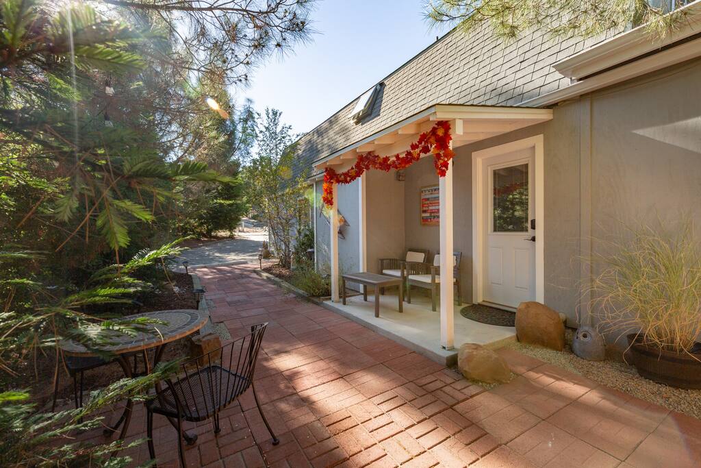Front entrance and private patio seating among the trees