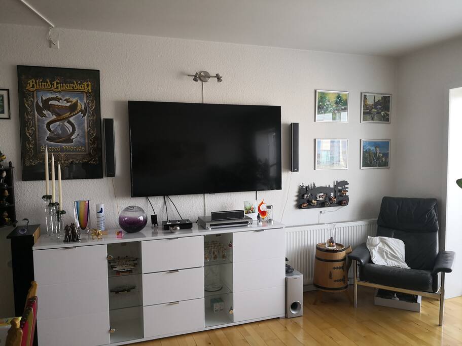 living room with 65 inc UHD TV on right side of the sideboard is bluray player and a 4K Ultra player left side bluray movie and Sony Surround on top