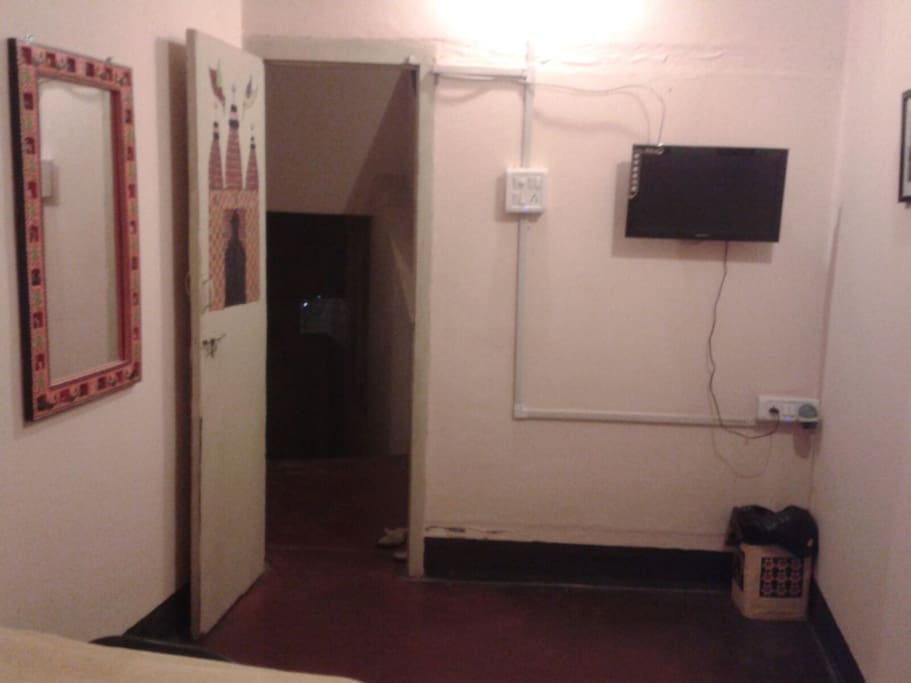 Small room has a TV and nice decor.
