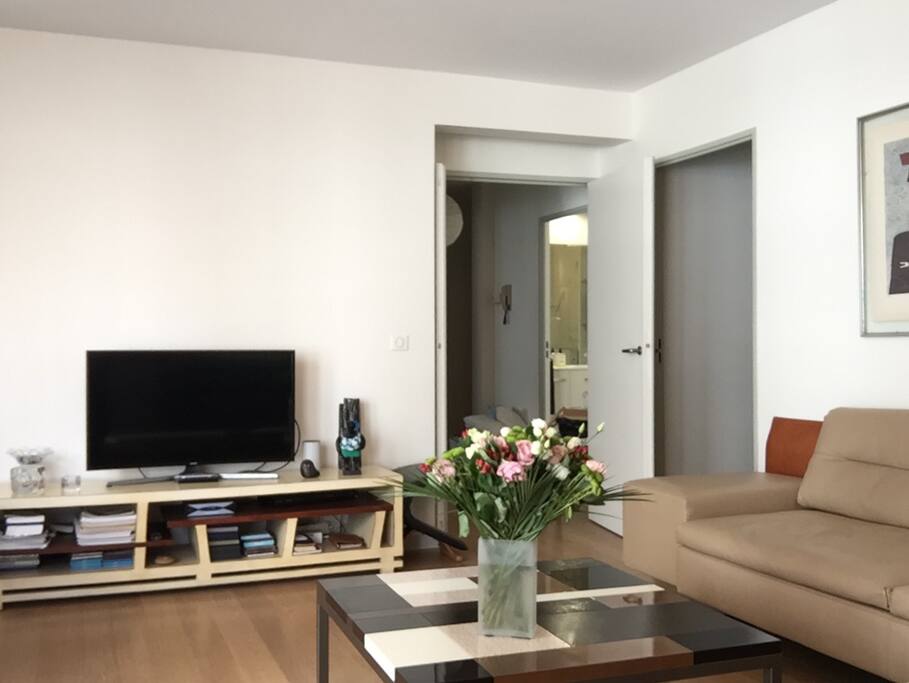 Living room / dining room, with flat screen tv and original Eames' chairs.