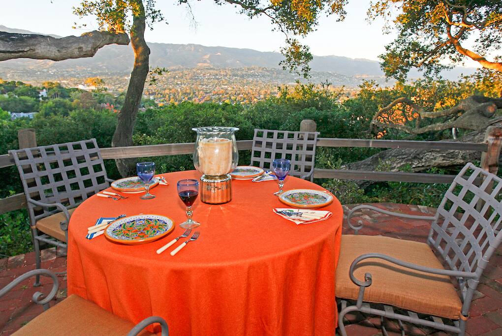 The terrace offers outdoor dining paired with an incredible vantage point of the mountains and city.