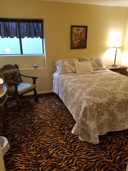 Bedroom has a fan, shoe shiner, alarm clock, heater and mirror