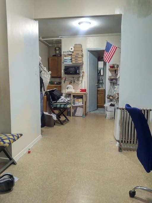 The living room, which is where your comfy futon bed will be when you arrive. And yes I'm in the middle of painting. :)