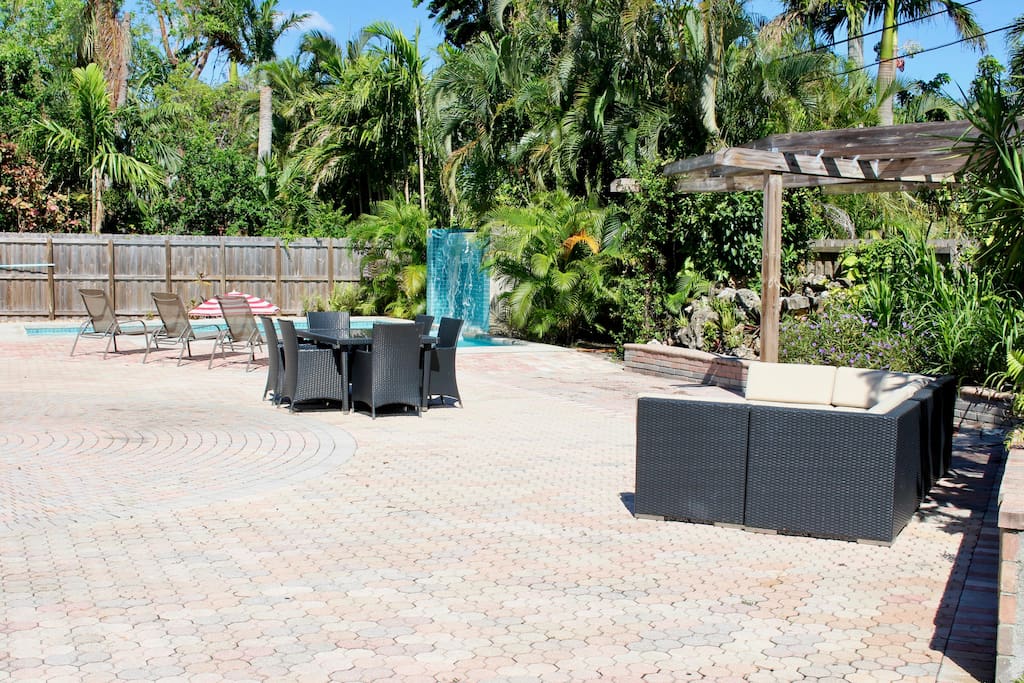 HUGE backyard with outdoor dining options, heated pool, children's playground, and additional grass and shrubbery spaces for playing in!