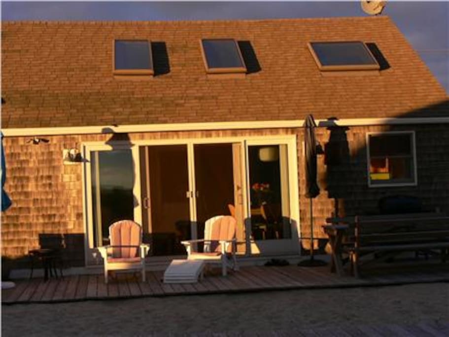 Private deck with Adirondack chairs, umbrella, gas grill and large picnic table