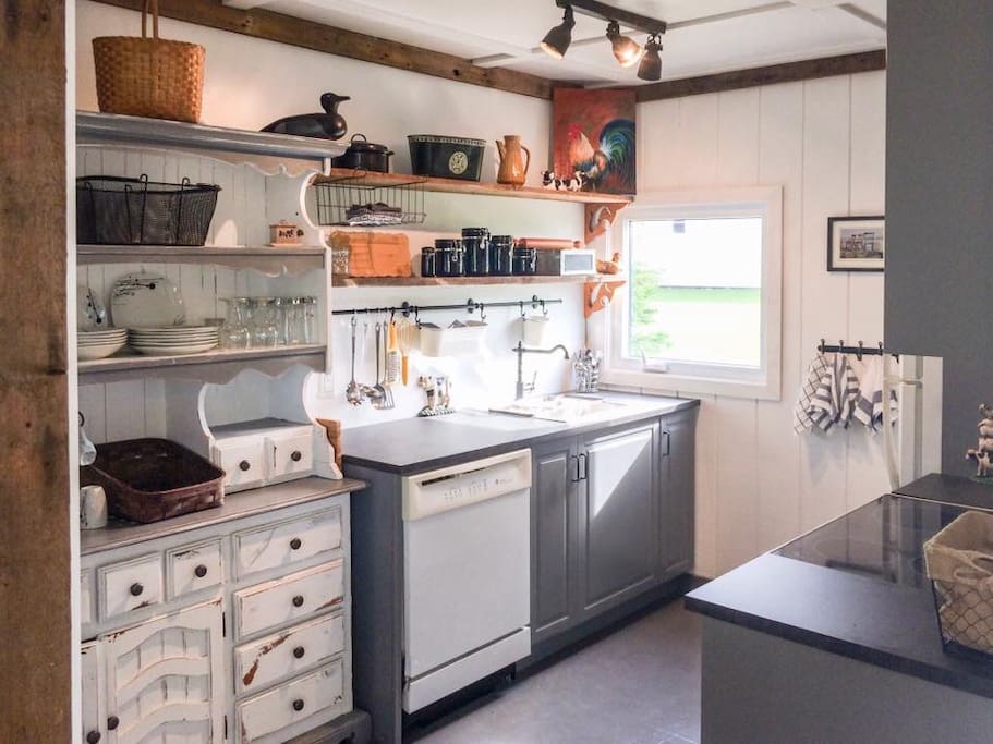Bright, fully stocked kitchen with barn board accents. You'll love it it here.