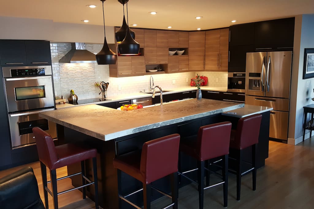 Chef's Kitchen with large island, two ovens and induction cooktop