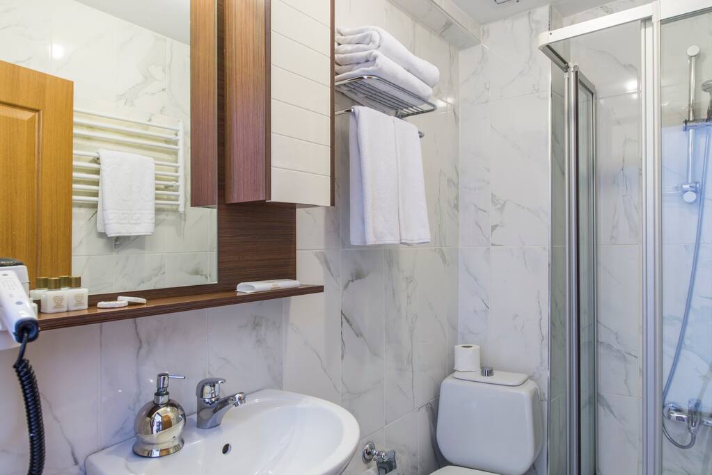 Spacious bathrooms with cabin shower . Complimentary soap, shampoo, slippers, towels, hair-dryer.