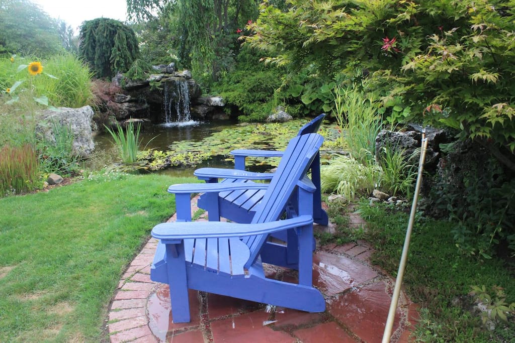Waterfall at pond in garden with sitting area