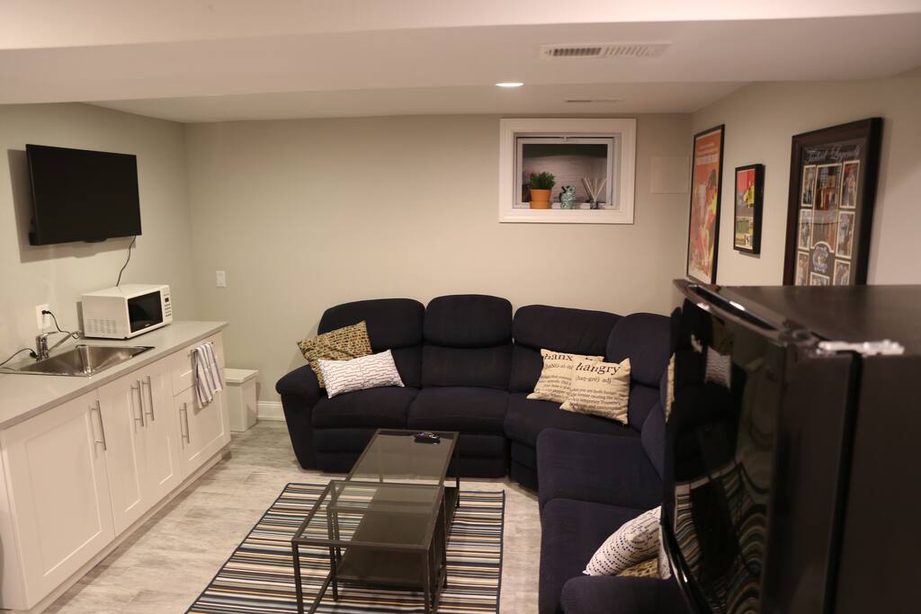 The kitchenette has a fridge, microwave, coffee maker, Brita pitcher, sink, dish rack, plates, cutlery, mugs, and glasses.