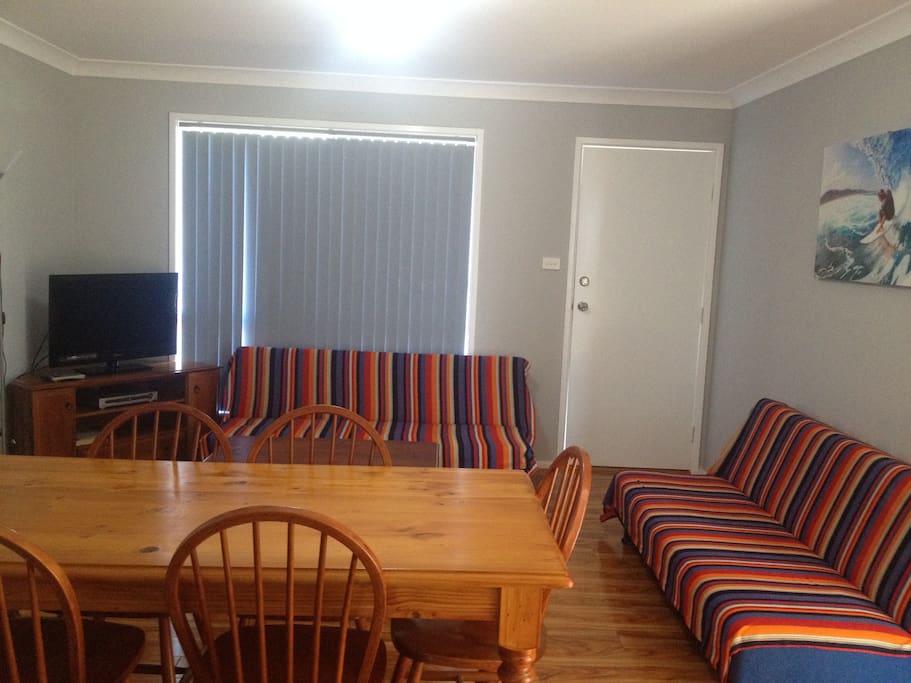 Lounge/Dining with 2 king single sofa beds