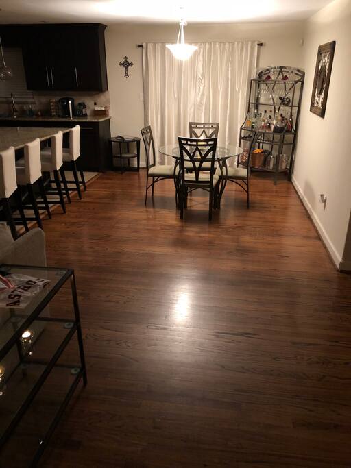 Dining room with French doors leading to the large backyard with plenty of seating and beautiful mature trees