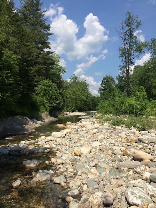 The inn includes a large deck overlooking the Mad River next to the Green Mountain National Forest, just a short walk along the river to the Warren Falls