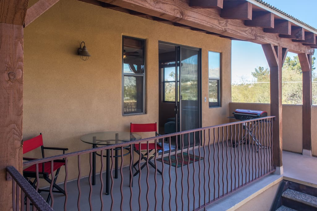 Your private entrance and porch, with an outdoor dining area and grill.