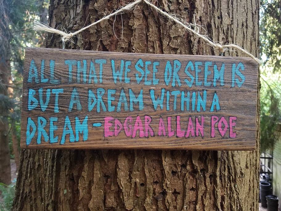 Uplifting signs hang on big beautiful trees