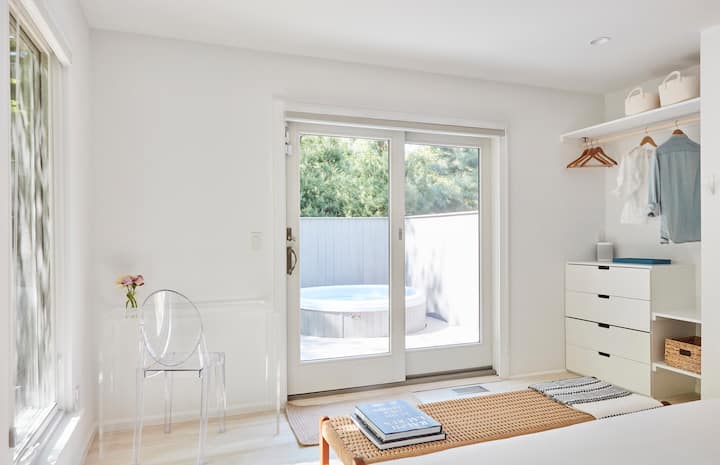 En-suite primary bedroom with home office and custom built-in closet. Sliders lead to hot tub & pool area. 