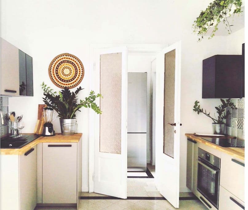 Our darling and fully equipped kitchen, with laundry area in the back.