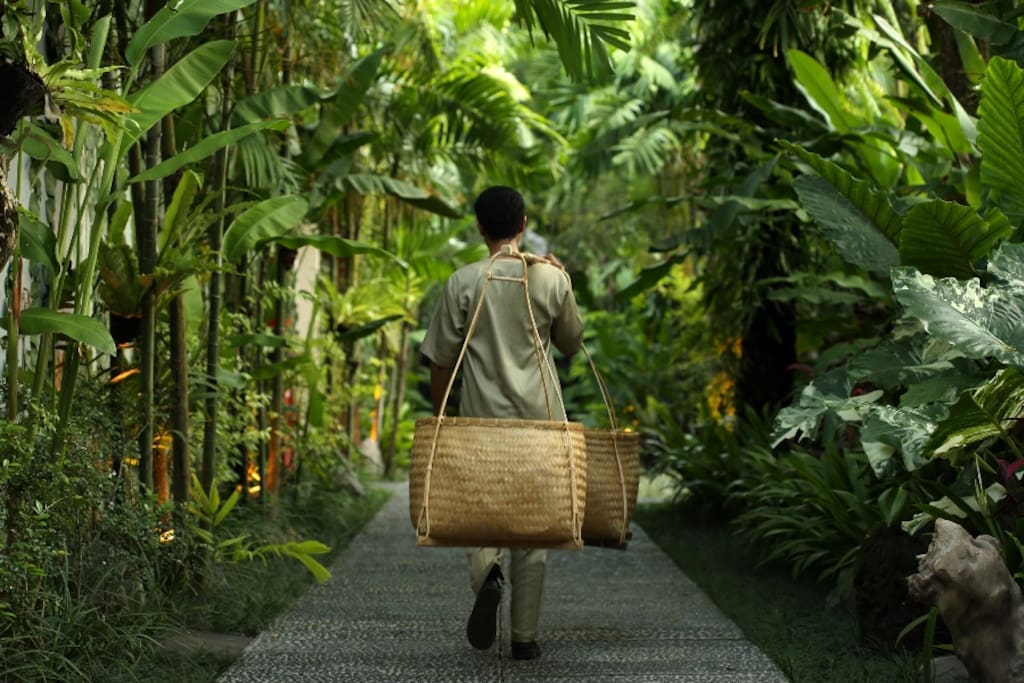 Personalised service: Housekeeper carrying amenities in an Indonesian vintage style.