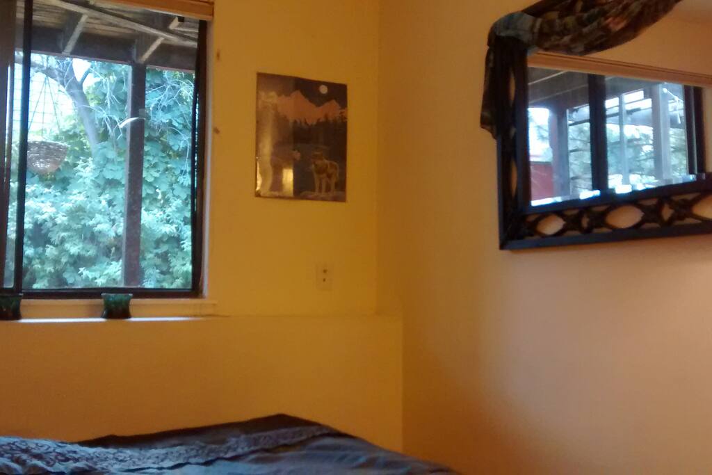 Zen bedroom, lots of light, big mirror reflecting outdoors and light