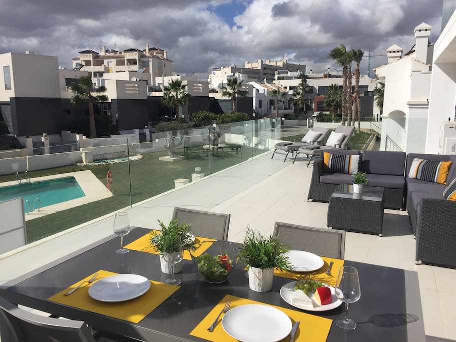 90m2 terrace with comfy seating, 4 sun loungers and dining