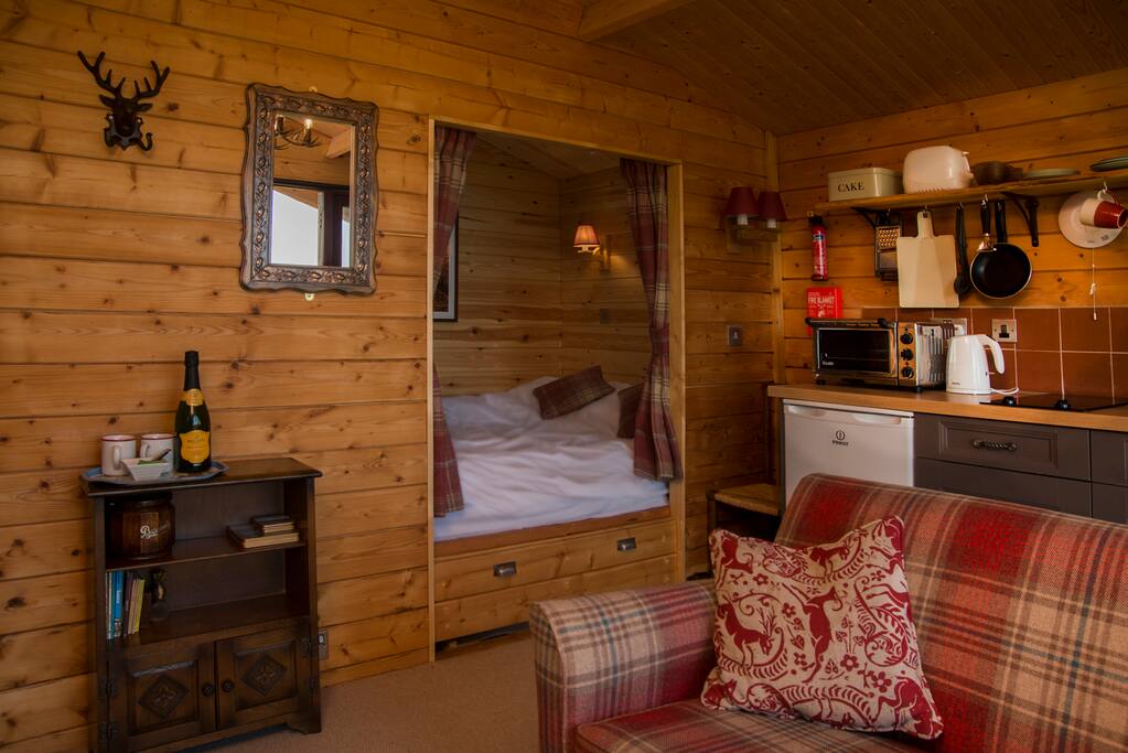 The living room and romantic cabin-styled king-size bed.