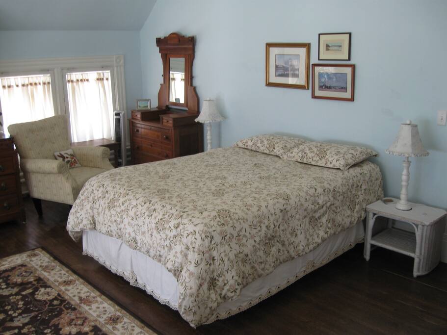 The Gillette Room: A light porch-like atmosphere with windows framing three sides of the room.